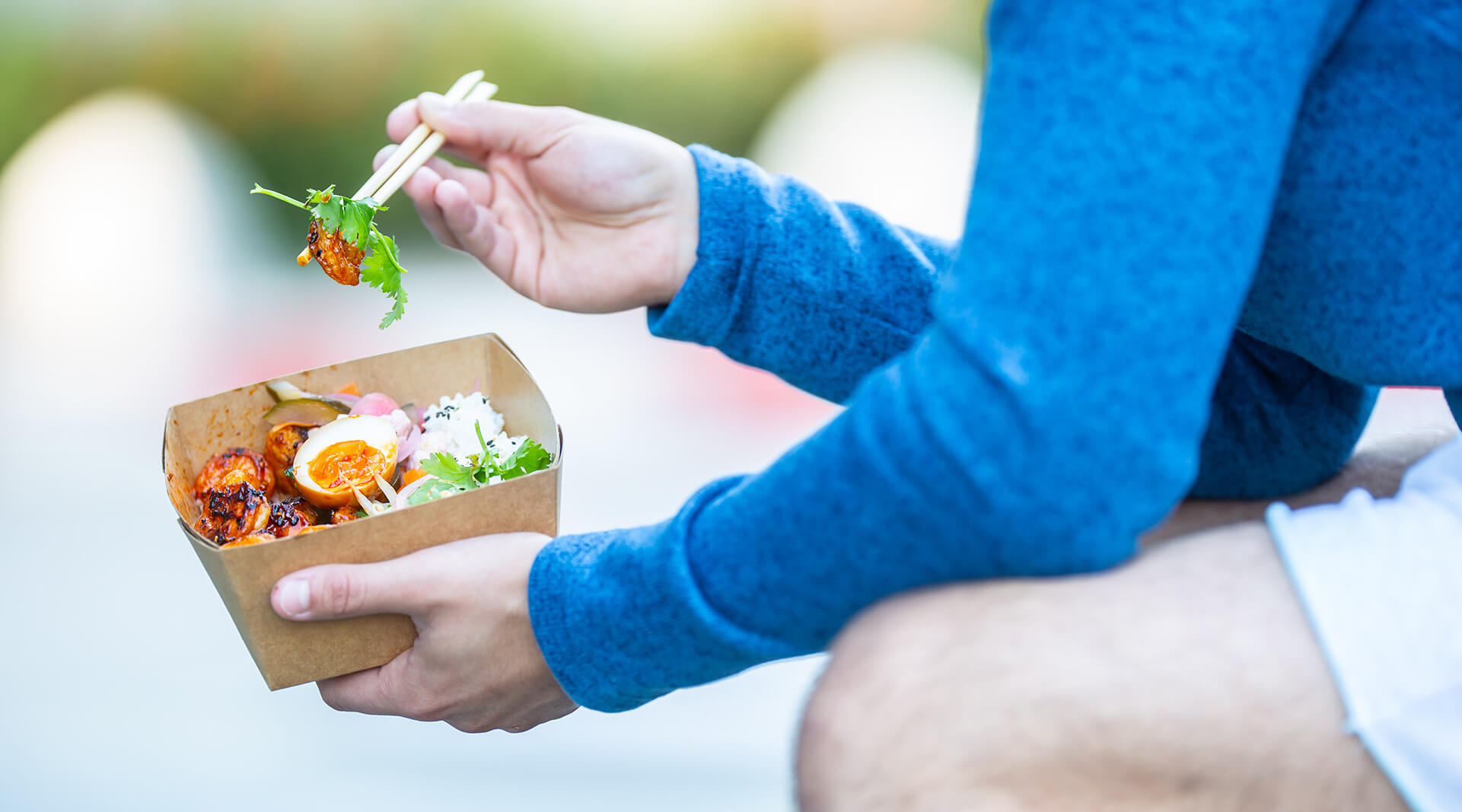 Person eating food out of a take-out container